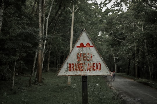 white and red road signage in Thekkady India