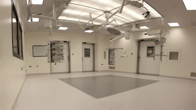 A skilled orthopedic surgeon carefully setting a fracture in a bright, modern operating room.
