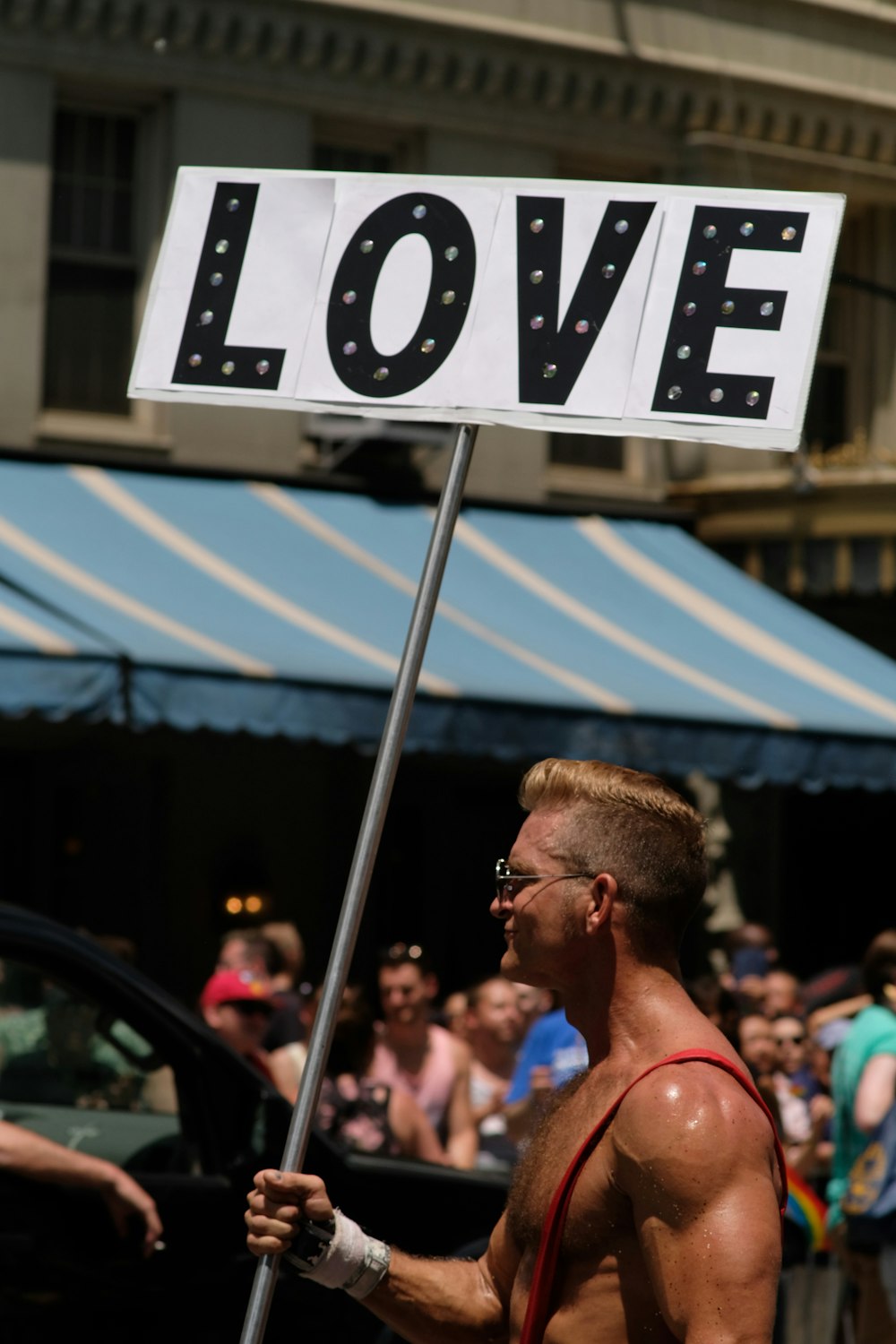 man holding love banner