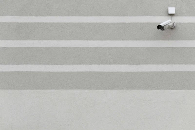 High-tech surveillance camera network monitoring a strategic border zone under navy and tactical green tones.