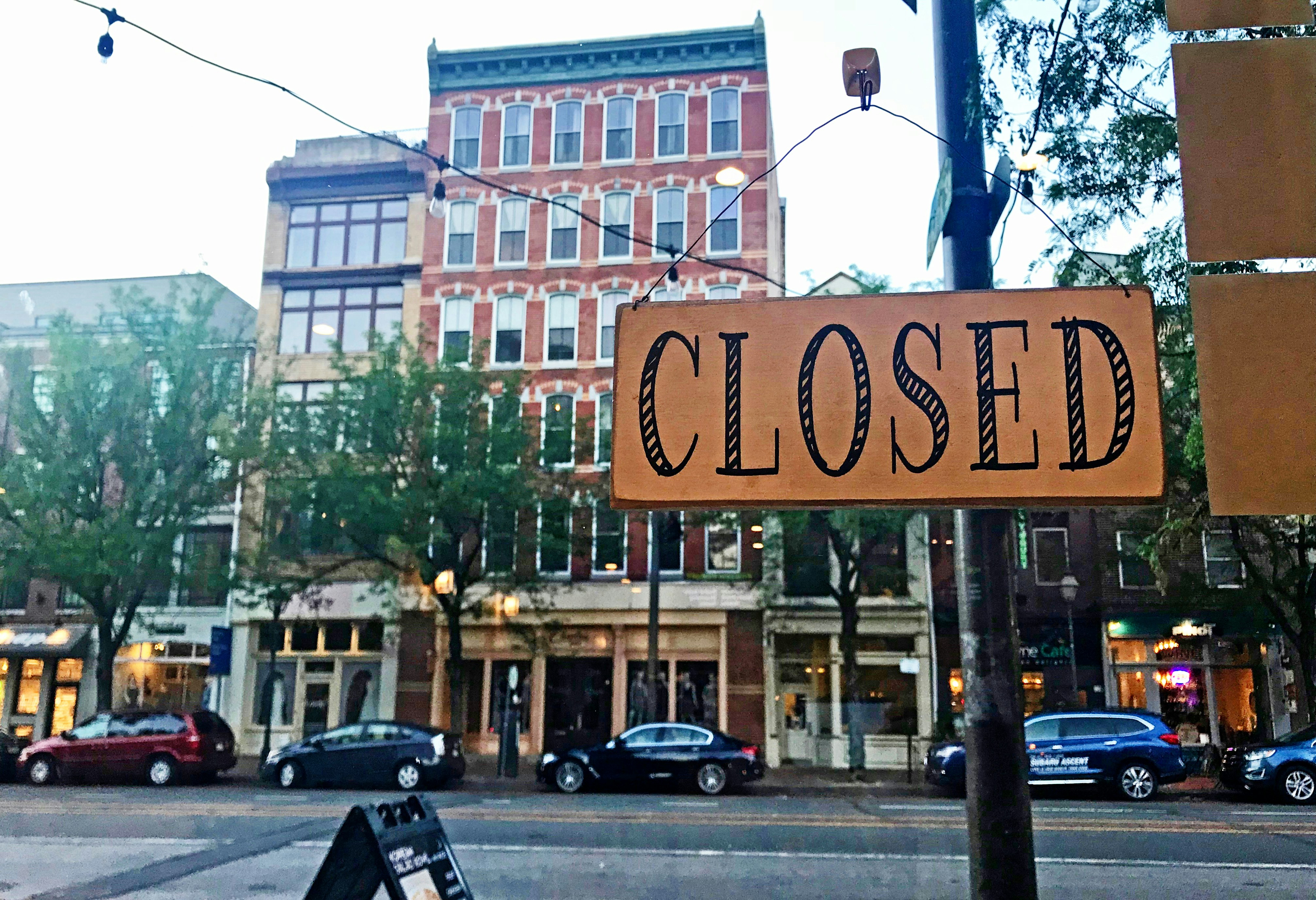 Closing a Business - Illustration of person locking up storefront