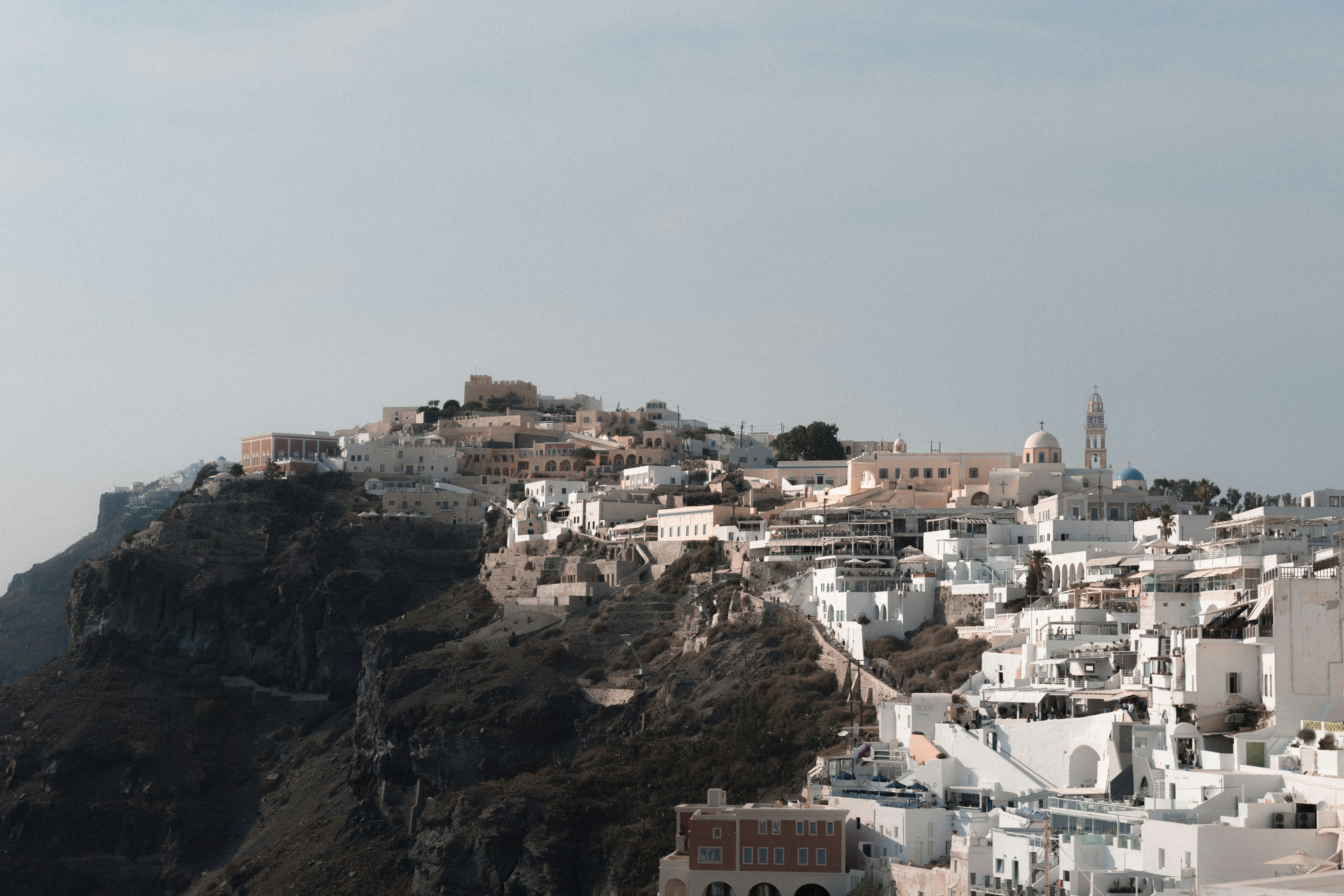 white building near cliff, Santorini Bluffs
