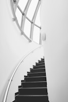 Close-up of a sleek black metal staircase with intricate railing details inside a modern home.