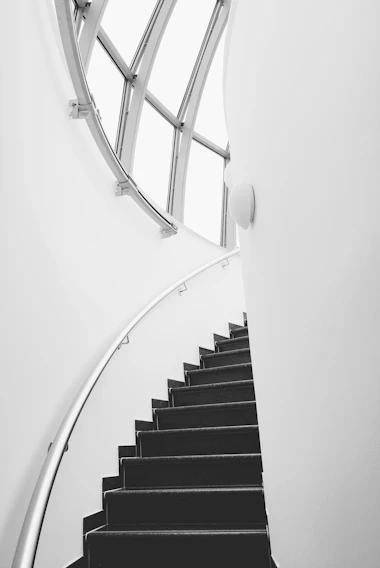 Close-up of a sleek black iron handrail installed on a modern staircase in a Columbia home.