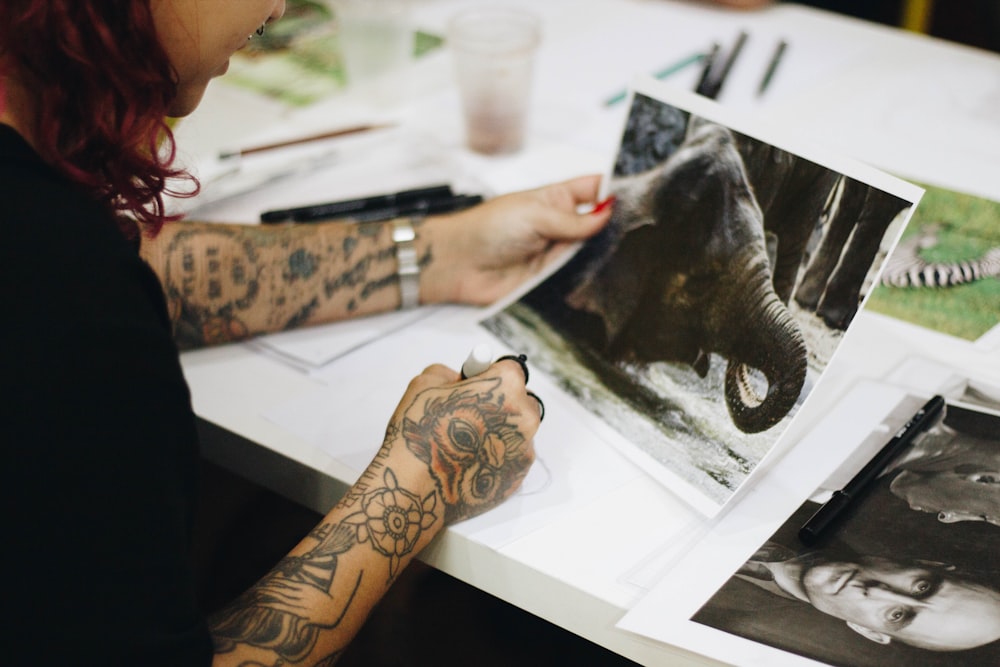 person holding a photo of elephant