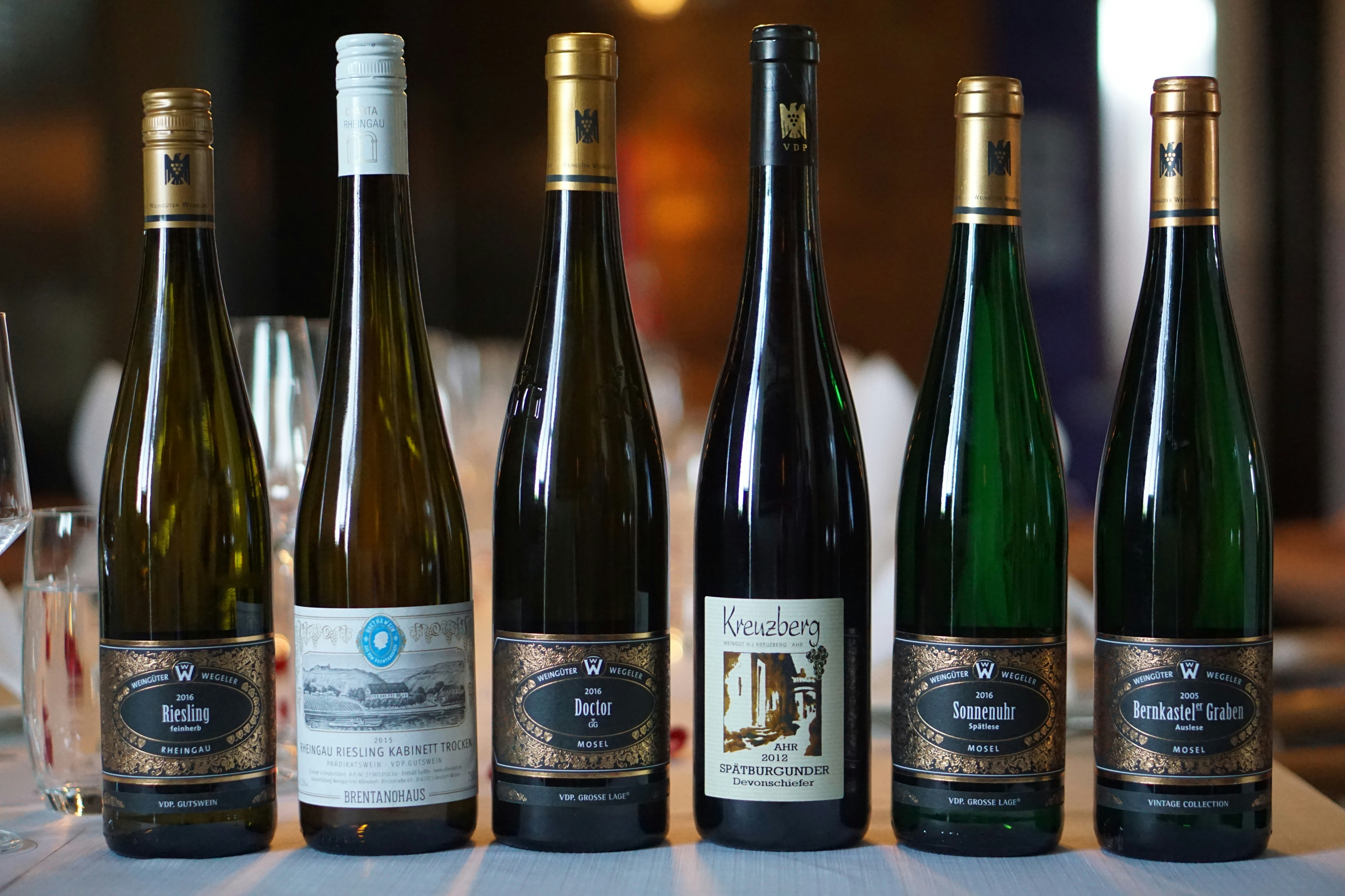 six assorted-color glass liquor bottles