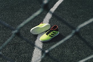 pair of green running shoes on floor