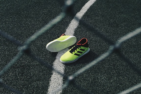 pair of green running shoes on floor