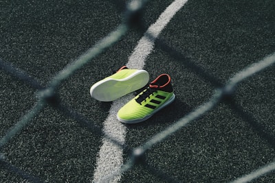 pair of green running shoes on floor