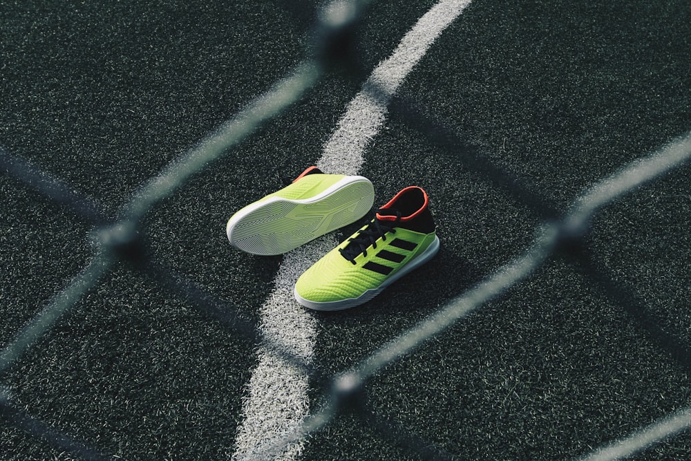 pair of green running shoes on floor