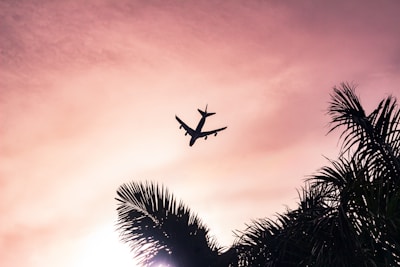 airplane under cloudy sky during daytime