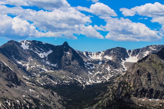 snow covered mountains under cloudy skies in Rocky Mountain National Park United States