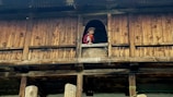 A child playing safely on a balcony secured with safety nets.