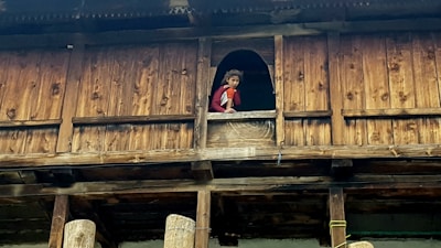 A child playing safely on a balcony with a net protecting the area.