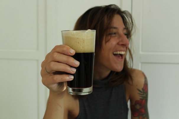 A cheerful customer enjoying a drink from juoda bačka.