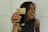 A happy customer enjoying a drink from juoda bačka.