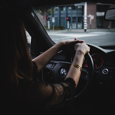 woman inside BMW car holding steering wheel