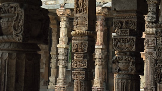 brown concrete pillars in Qutub Minar India