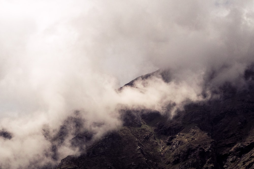 brown mountain covered with clouds