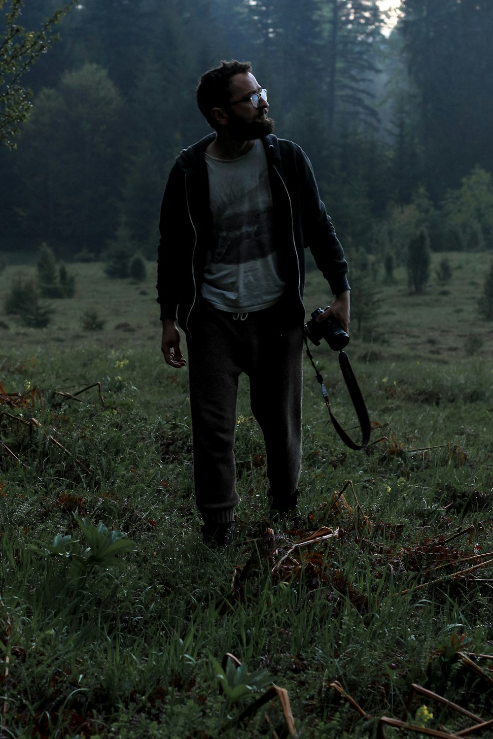 man holding camera on grass field