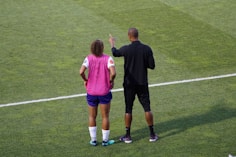 man and woman standing on field