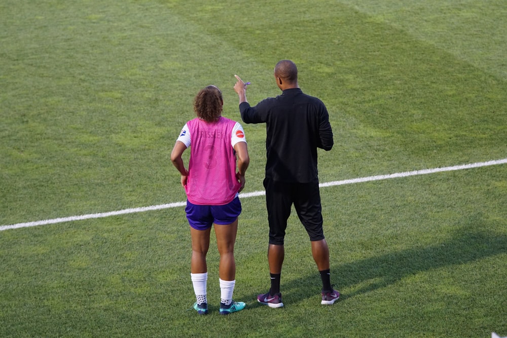 man and woman standing on field