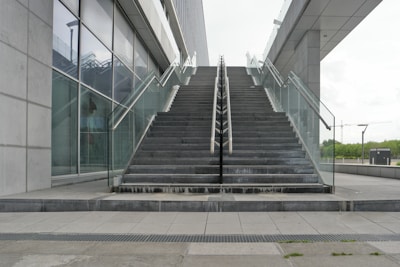 An outdoor metal staircase leading to a contemporary building.
