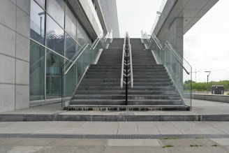 An outdoor metal staircase leading to a contemporary building.