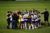 A vibrant team huddle, showcasing unity and determination among young players.
