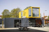 A sturdy shipping container converted into a functional living space with vibrant exterior paint