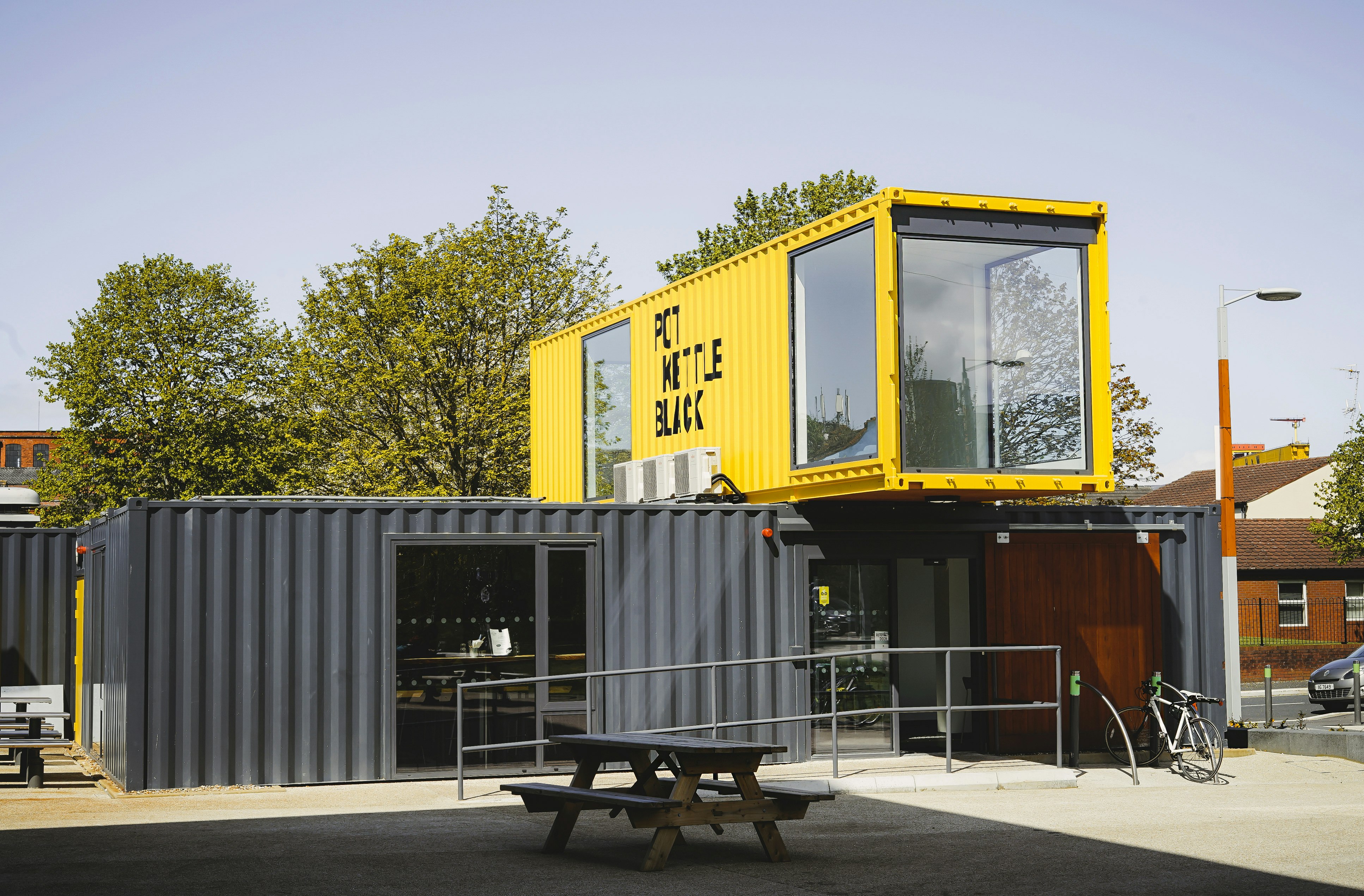 grey and yellow metal container van during daytime