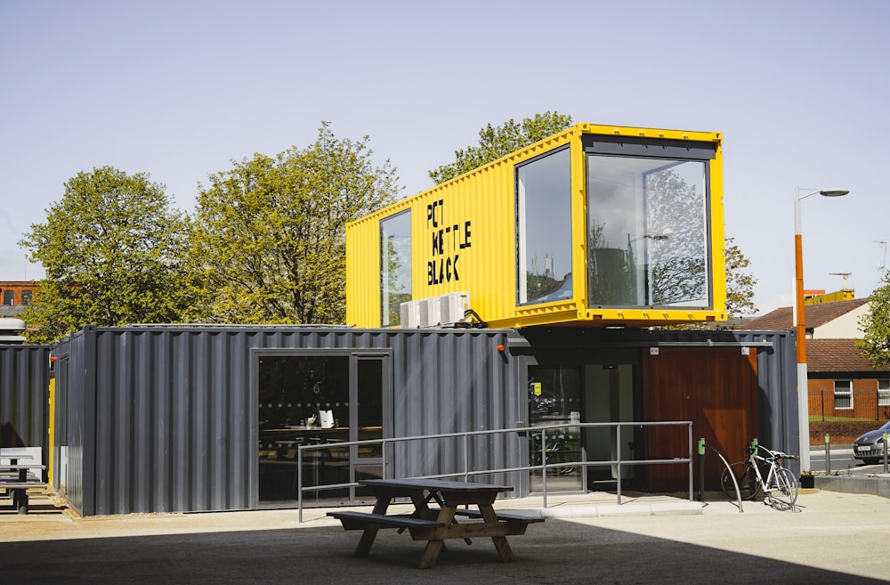 grey and yellow metal container van during daytime