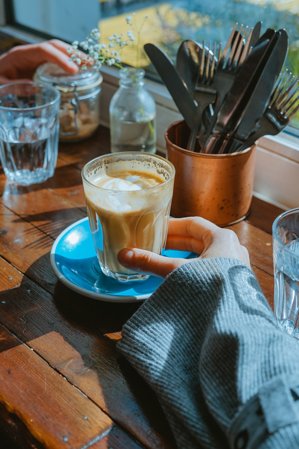 person holding clear drinking glass