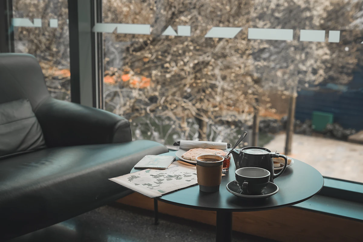 Tea and coffee cups arranged on a relaxed cafe table