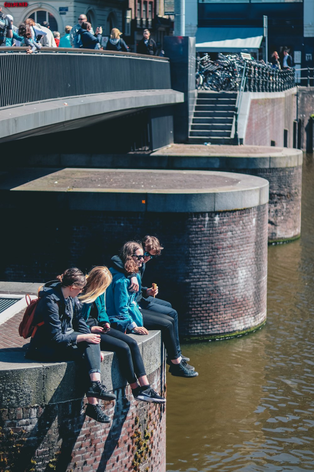 four people sitting near bridge