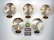 Five wall clocks each displaying different time zones are mounted on a wall, labeled Saipan, Moscow, Beijing, Seoul, and Tokyo. Beneath the clocks, there is a decorative sign with the words 'On Beach Time' in green, pink, and blue hues.