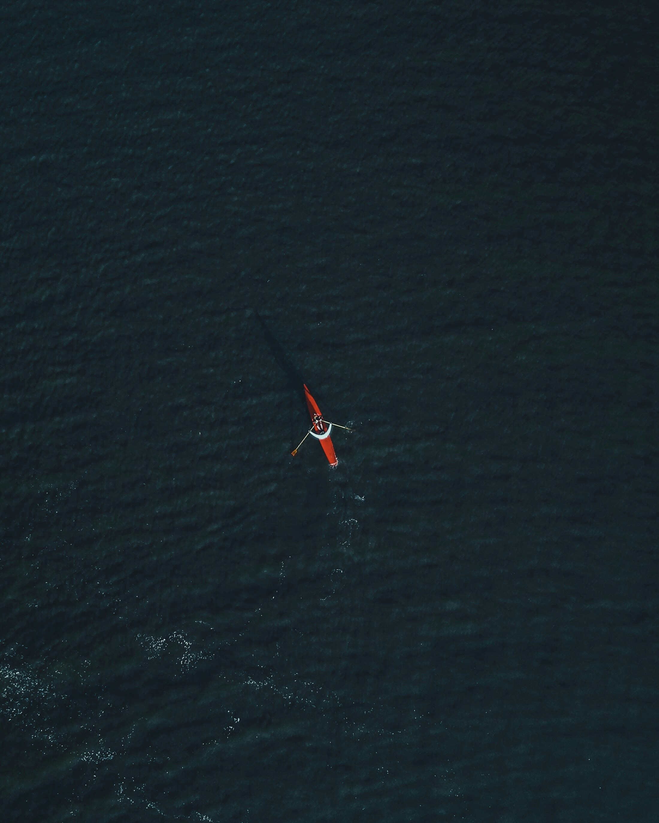 aerial photography of person riding on kayak during daytime