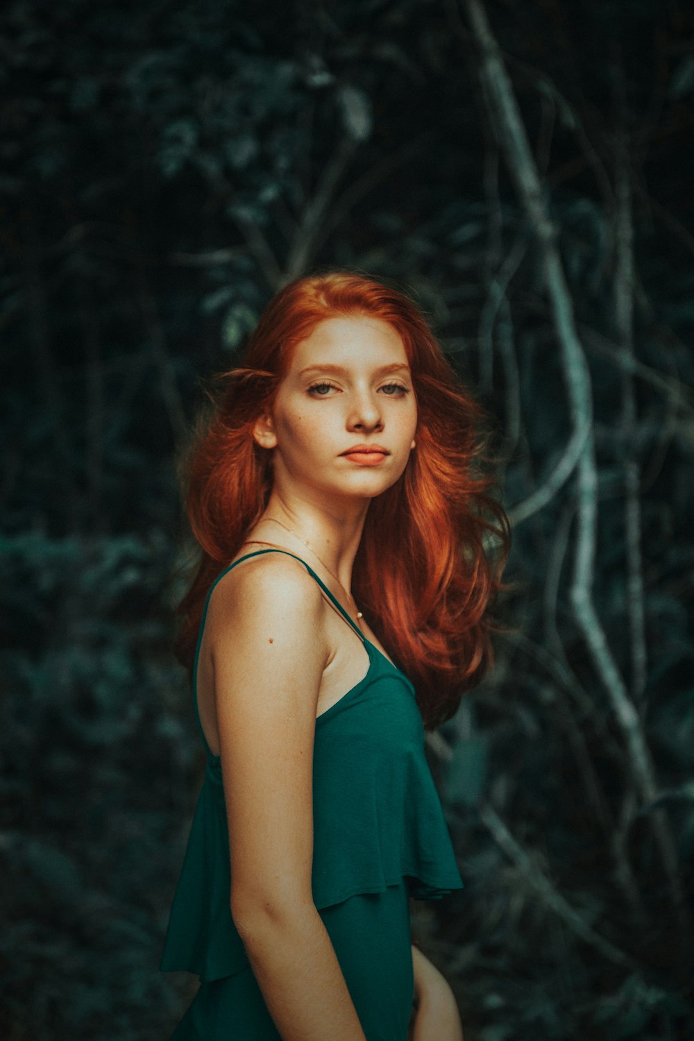 woman wearing teal noodle strap dress