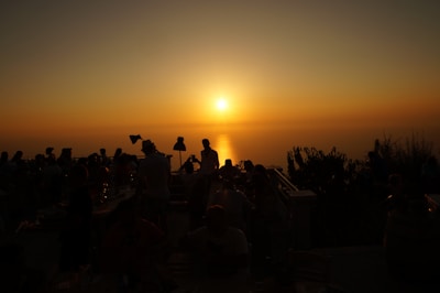 Guests enjoying a sunset cocktail on the terrace with panoramic ocean views.