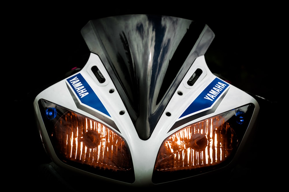 white and blue Yamaha sport bike powered-on headlight