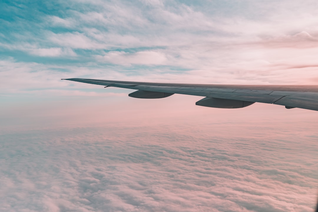 flying plane above sky white plane wing,