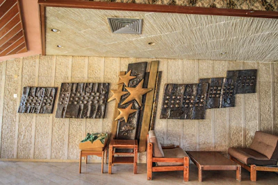 Intricate metal wall art installation blending form and function in a stylish living room.