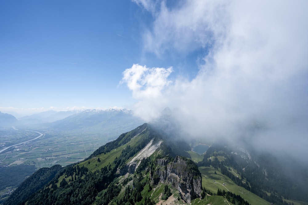 a view of the top of a mountain in the clouds