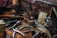 Close-up of a skilled cobbler repairing a worn leather shoe with precise tools.