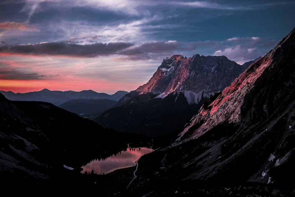 mountains with fog under blue and orange sky