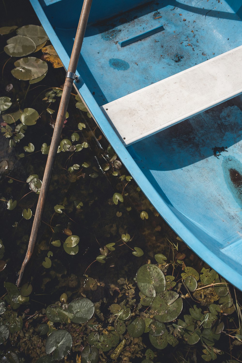 blue boat on body of water during day time