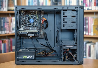 black computer tower on brown wooden table