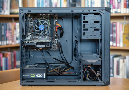 black computer tower on brown wooden table