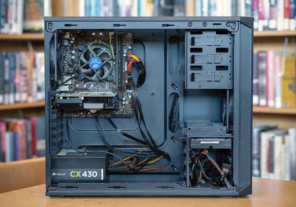 black computer tower on brown wooden table