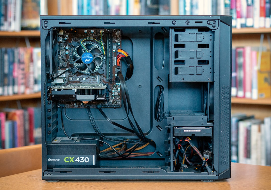 black computer tower on brown wooden table